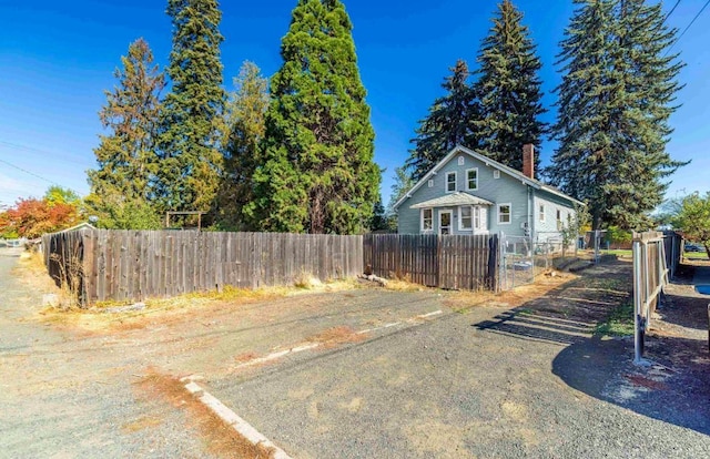18 N 7th St, Cheney, WA 99004 - view of home's exterior featuring a chimney and a fenced front yard