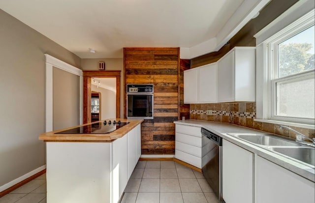 18 N 7th St, Cheney, WA 99004 - kitchen featuring black appliances, a sink, white cabinets, and baseboards