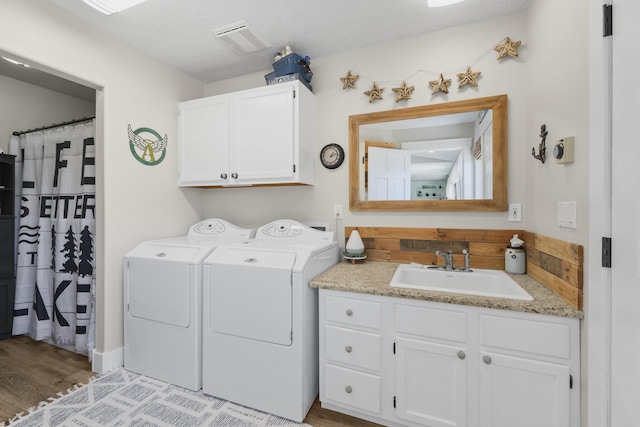 12621 N E Newman Lake Dr, Newman Lake, WA 99025 - washroom with cabinet space, washer and dryer, and wood finished floors