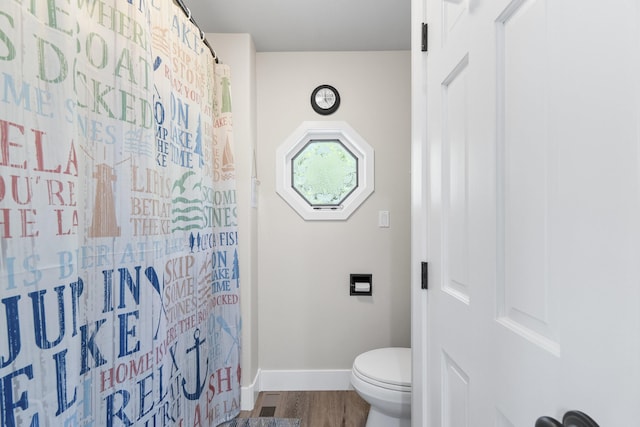 12621 N E Newman Lake Dr, Newman Lake, WA 99025 - bathroom with baseboards, toilet, wood finished floors, and a shower with shower curtain