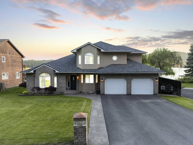 12621 N E Newman Lake Dr, Newman Lake, WA 99025 - view of front facade featuring a garage, asphalt driveway, a front yard, central AC unit, and a shingled roof