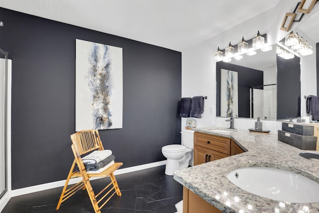 8310 E Bull Pine Ln, Spokane, WA 99217 - bathroom with double vanity, toilet, a shower, marble finish floors, and baseboards