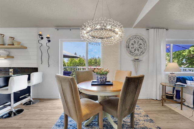 8310 E Bull Pine Ln, Spokane, WA 99217 - dining room featuring a chandelier and light wood-style flooring