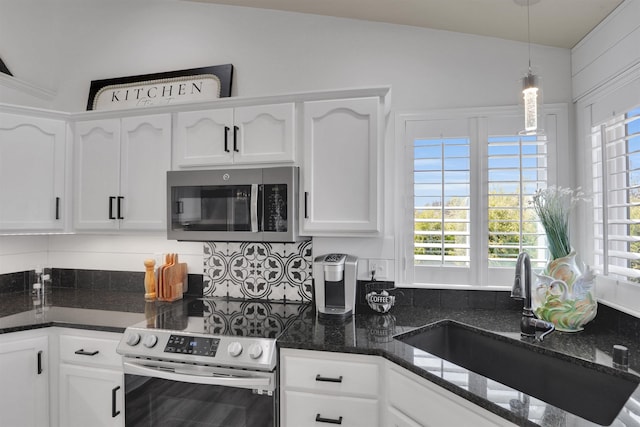 8310 E Bull Pine Ln, Spokane, WA 99217 - kitchen with appliances with stainless steel finishes, a sink, white cabinetry, backsplash, and pendant lighting