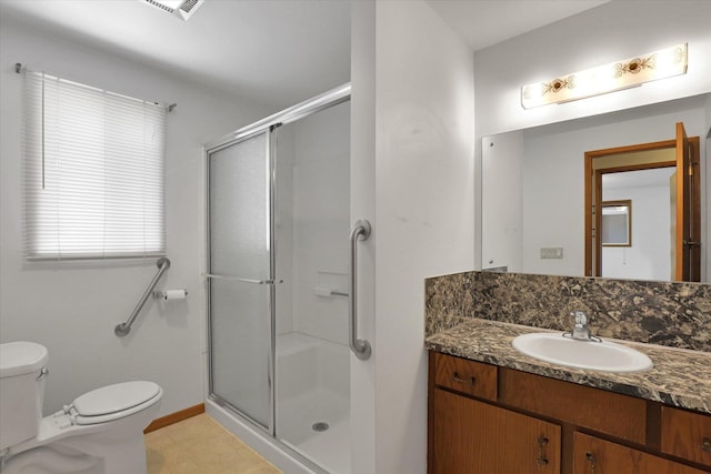 2651 E 35th Ave, Spokane, WA 99223 - bathroom with toilet, vanity, a shower with shower door, and baseboards