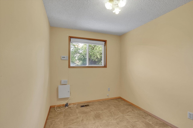 2651 E 35th Ave, Spokane, WA 99223 - spare room featuring a textured ceiling and baseboards