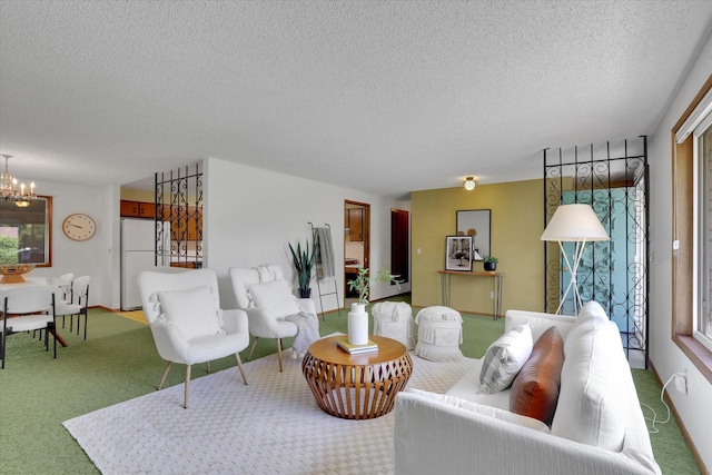 2651 E 35th Ave, Spokane, WA 99223 - living area featuring a chandelier, a textured ceiling, and carpet flooring