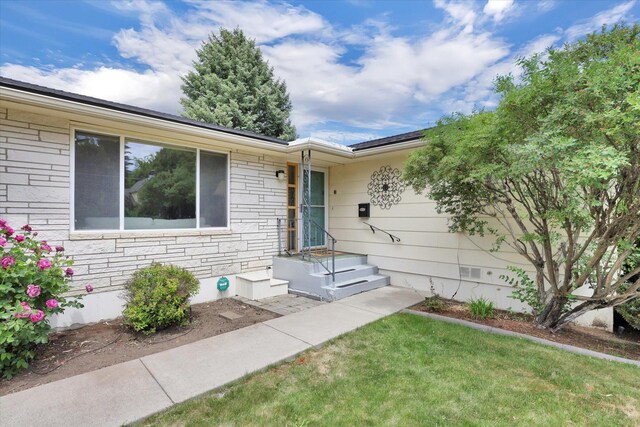 2651 E 35th Ave, Spokane, WA 99223 - doorway to property featuring a yard and stone siding