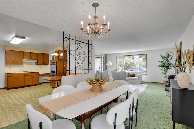 2651 E 35th Ave, Spokane, WA 99223 - dining area featuring light carpet, a chandelier, a textured ceiling, and baseboards