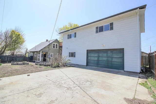 1427 E Bridgeport Ave, Spokane, WA 99207 - rear view of house featuring an attached garage and concrete driveway