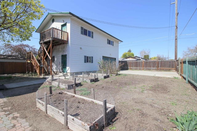 1427 E Bridgeport Ave, Spokane, WA 99207 - rear view of house featuring a vegetable garden, stairway, a fenced backyard, and a wooden deck