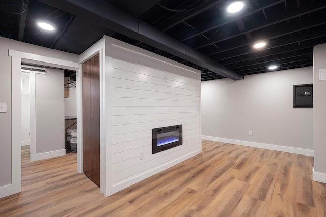 3617 N Edgerton Rd, Spokane Valley, WA 99212 - finished basement with light wood-style flooring, baseboards, and a large fireplace