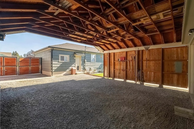 3617 N Edgerton Rd, Spokane Valley, WA 99212 - misc room featuring vaulted ceiling, wooden walls, healthy amount of natural light, and carpet