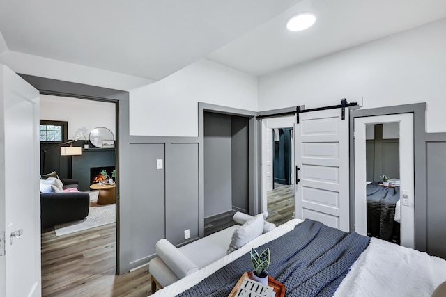 613 W Kiernan Ave, Spokane, WA 99205 - bedroom featuring wood finished floors and a barn door