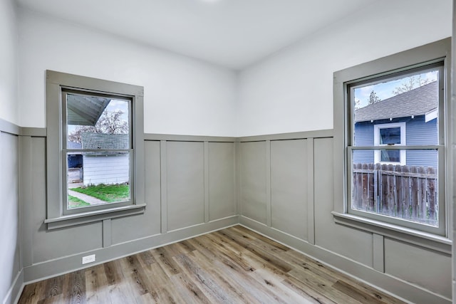 613 W Kiernan Ave, Spokane, WA 99205 - unfurnished room with a decorative wall, wood finished floors, and wainscoting