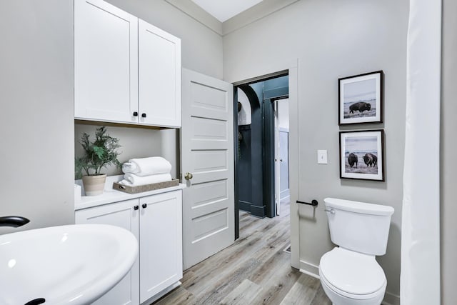 613 W Kiernan Ave, Spokane, WA 99205 - bathroom with wood finished floors, a sink, and toilet
