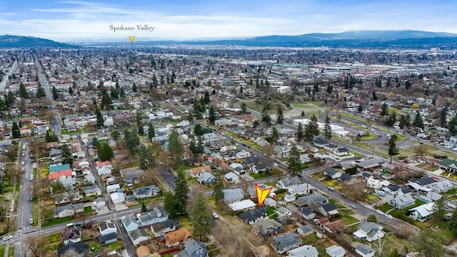 613 W Kiernan Ave, Spokane, WA 99205 - aerial overview of property's location with a mountain backdrop and nearby suburban area