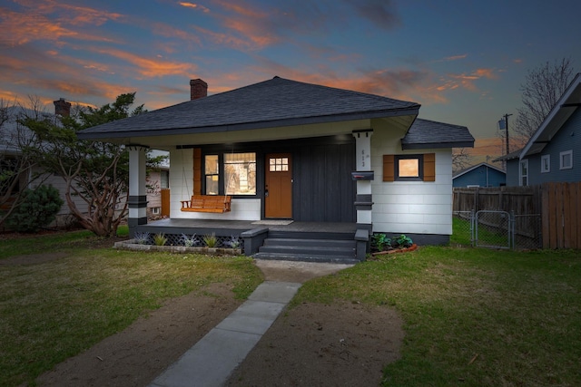 613 W Kiernan Ave, Spokane, WA 99205 - bungalow featuring a chimney, roof with shingles, covered porch, and a gate