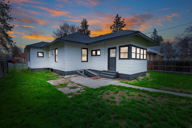 613 W Kiernan Ave, Spokane, WA 99205 - back of property at dusk with entry steps and roof with shingles