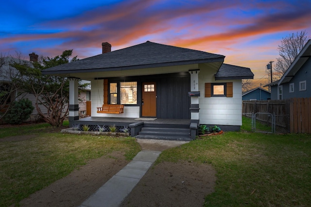 613 W Kiernan Ave, Spokane, WA 99205 - view of front of home with roof with shingles, covered porch, a chimney, and a gate