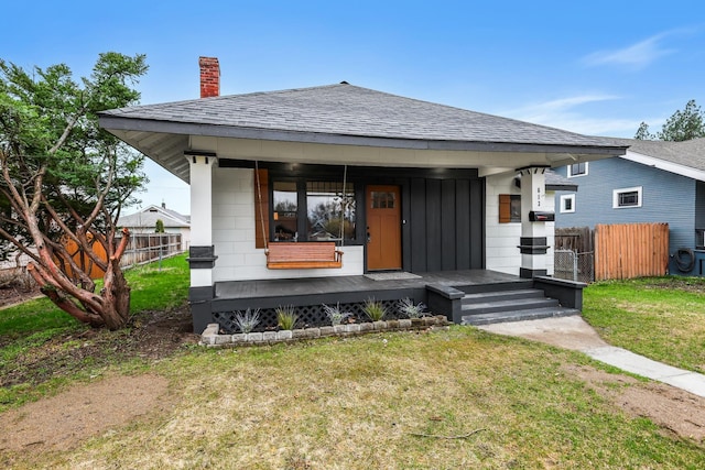 613 W Kiernan Ave, Spokane, WA 99205 - view of front of house featuring a chimney, roof with shingles, and covered porch