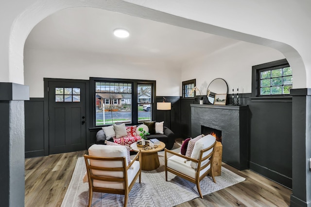 613 W Kiernan Ave, Spokane, WA 99205 - living room featuring arched walkways, a high end fireplace, and wood finished floors