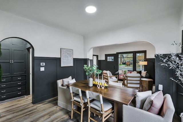613 W Kiernan Ave, Spokane, WA 99205 - dining room with arched walkways, a wainscoted wall, and light wood-style floors
