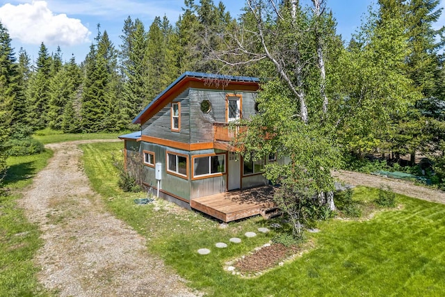 1100 Graham Rd, Cusick, WA 99119 - rear view of property featuring a wooden deck, driveway, a yard, and a wooded view