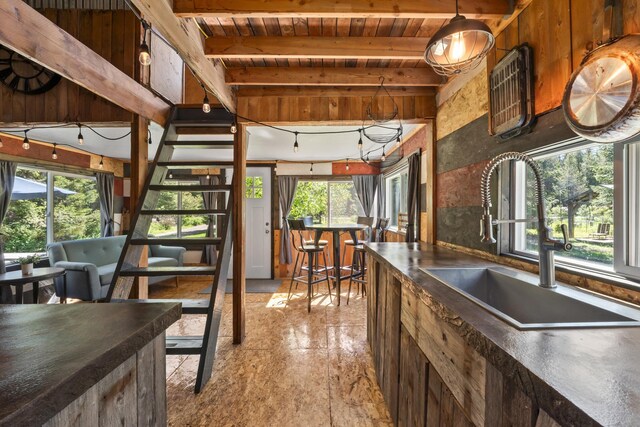 1100 Graham Rd, Cusick, WA 99119 - kitchen with a sink, wooden ceiling with exposed beams, dark countertops, and hanging light fixtures