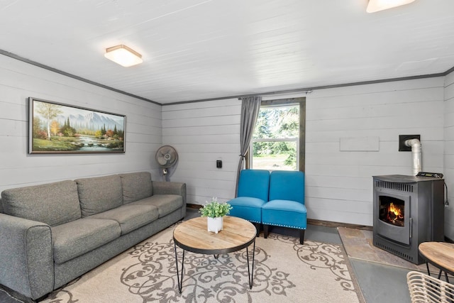 1100 Graham Rd, Cusick, WA 99119 - living area with a wood stove, concrete flooring, and wooden walls