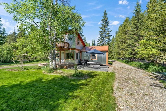 1100 Graham Rd, Cusick, WA 99119 - rear view of property featuring a yard, a deck, a patio area, and metal roof