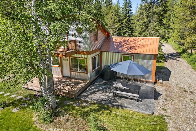 1100 Graham Rd, Cusick, WA 99119 - rear view of house with a patio area, metal roof, and a wooden deck