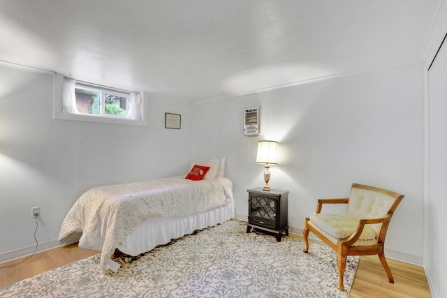 1211 W 17th Ave, Spokane, WA 99203 - bedroom featuring wood finished floors, baseboards, and a wall mounted AC