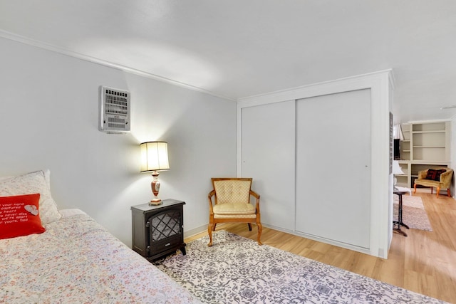 1211 W 17th Ave, Spokane, WA 99203 - bedroom featuring ornamental molding, wood finished floors, a wall mounted AC, and a closet