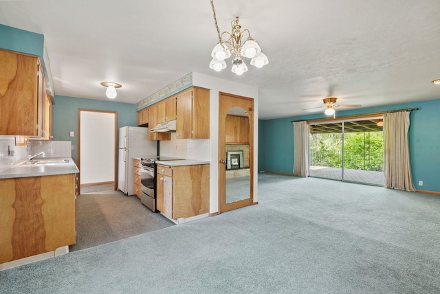 11132 S Silver Lake Rd, Medical Lake, WA 99022 - kitchen featuring stainless steel range with electric stovetop, under cabinet range hood, decorative backsplash, and light carpet