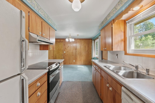 11132 S Silver Lake Rd, Medical Lake, WA 99022 - kitchen with white appliances, under cabinet range hood, a sink, light carpet, and decorative backsplash