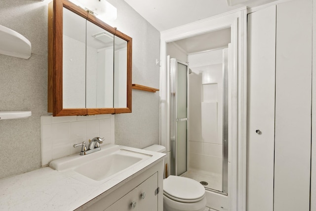 11132 S Silver Lake Rd, Medical Lake, WA 99022 - full bathroom featuring toilet, decorative backsplash, a shower stall, and vanity