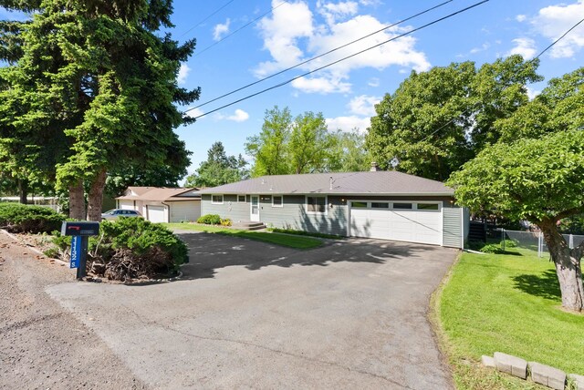11132 S Silver Lake Rd, Medical Lake, WA 99022 - single story home featuring asphalt driveway and a garage