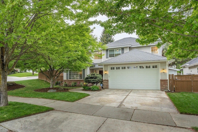 6730 S Moran View St, Spokane, WA 99224 - view of front of house with brick siding, concrete driveway, an attached garage, and roof with shingles