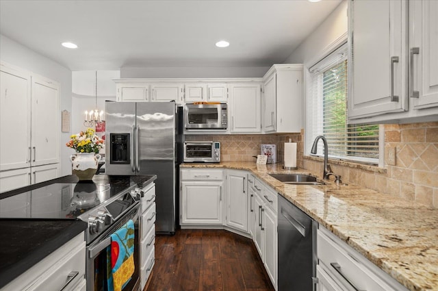 6730 S Moran View St, Spokane, WA 99224 - kitchen featuring a sink, stainless steel appliances, white cabinets, light stone counters, and dark wood-type flooring