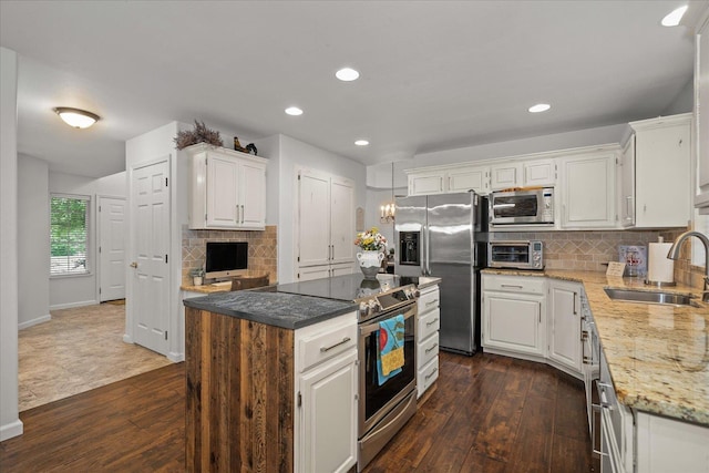 6730 S Moran View St, Spokane, WA 99224 - kitchen featuring appliances with stainless steel finishes, a sink, dark wood-style floors, white cabinets, and recessed lighting