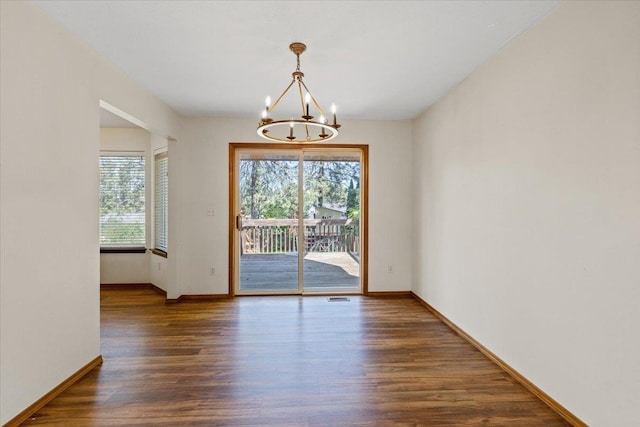 4227 E 38th Ave, Spokane, WA 99223 - unfurnished room featuring a chandelier, plenty of natural light, wood finished floors, and baseboards