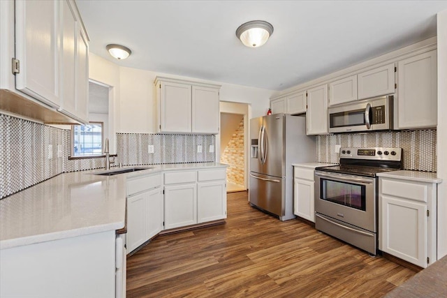 4227 E 38th Ave, Spokane, WA 99223 - kitchen featuring stainless steel appliances, tasteful backsplash, dark wood-style flooring, a sink, and light countertops