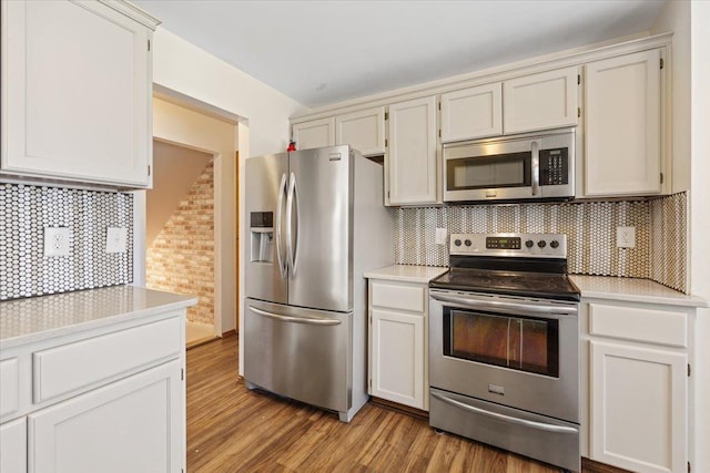 4227 E 38th Ave, Spokane, WA 99223 - kitchen with stainless steel appliances, light countertops, decorative backsplash, and light wood-style floors