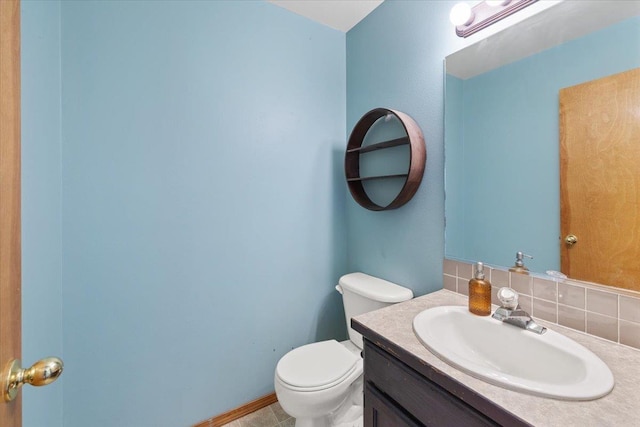 4227 E 38th Ave, Spokane, WA 99223 - bathroom with vanity, toilet, and decorative backsplash