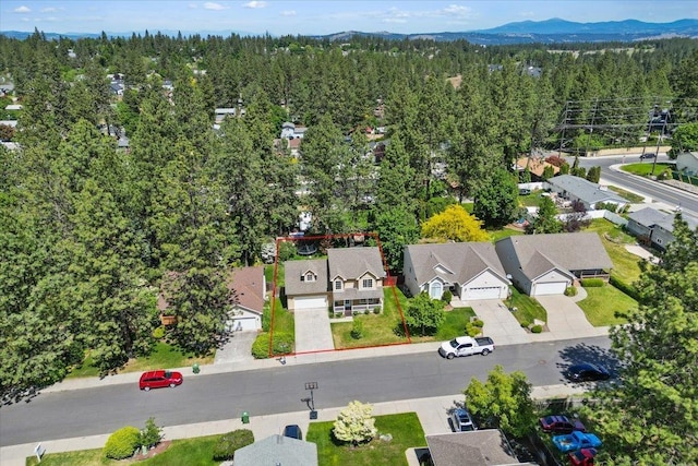 4227 E 38th Ave, Spokane, WA 99223 - aerial view of residential area featuring property boundaries highlighted, a forest, and a mountainous background