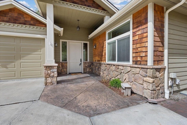 223 N Lindeblad Ln, Liberty Lake, WA 99019 - property entrance featuring stone siding, concrete driveway, and a garage