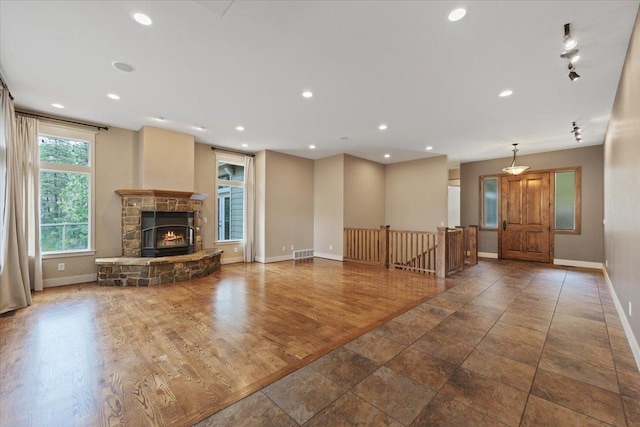 223 N Lindeblad Ln, Liberty Lake, WA 99019 - unfurnished living room featuring baseboards, a stone fireplace, recessed lighting, and wood finished floors