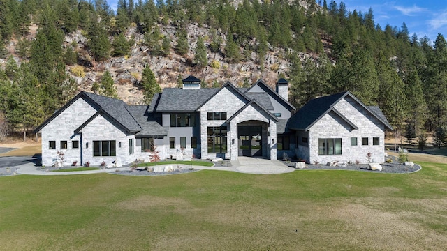 13858 N Boulder Park Ln, Spokane, WA 99208 - rear view of property featuring stone siding, a chimney, and a yard