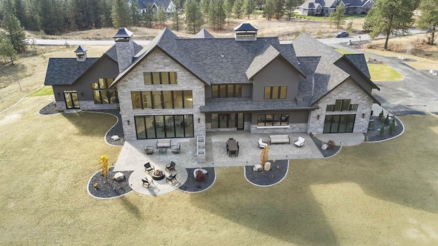 13858 N Boulder Park Ln, Spokane, WA 99208 - rear view of house with stone siding, a shingled roof, a chimney, and a patio
